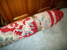 A large red patterned wool carpet