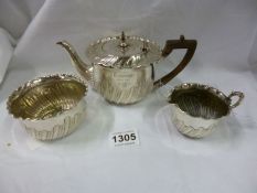 An ornate 3 piece silver tea set (approx. 450 grammes)