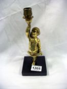 A brass Putti candlestick on marble base