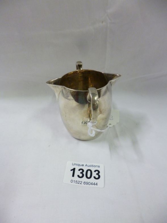 A silver twin lipped cream jug, 110 grammes