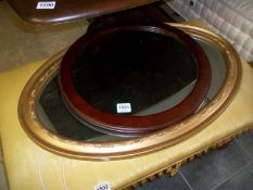 An oval gilt framed mirror and one other