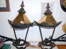 A pair of outside lanterns with brackets and glass
