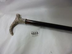 An ornate silver topped cane