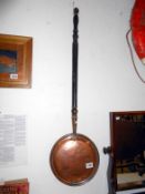 A Victorian copper warming pan