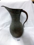 An early Middle Eastern metal jug, 32cm tall