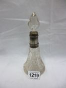 A cut glass perfume bottle with silver collar