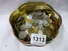 A tin of mixed foreign coins