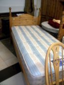 A single pine bed with mattress