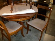 An inlaid dining table and set of 4 brass inlaid chairs