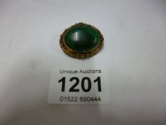 An early 20th century photo brooch set large green stone