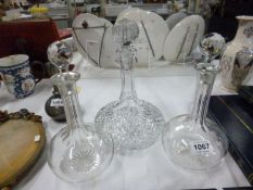 A cut glass ship's decanter and a pair of glass decanters