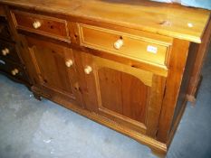 A pine 2 door, 2 drawer cupboard