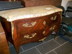 An ormolu mounted bombe front chest with marble top
