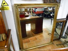 A large gilt framed mirror