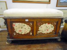 An ornately carved blanket box with floral panels