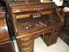 A Victorian roll top desk with integral inkwells