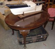 An oval mahogany dining table