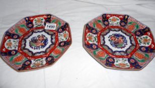 A pair of 19th century hand painted and gilded Imari plates