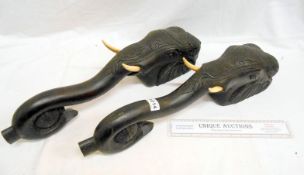 A pair of carved hardwood elephant heads