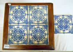 4 framed blue and white tiles and one matching loose tile