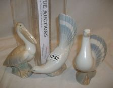 2 porcelain doves and a pelican