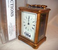 A brass carriage clock (front glass has chips)