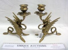 A pair of brass dragon candlesticks