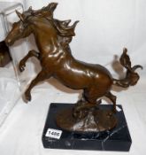 A bronze rearing horse on marble base