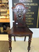 A Victorian carved mahogany hall chair