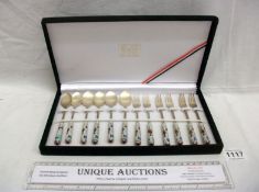 A cased set of desert spoons and forks