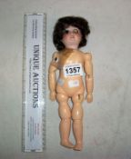 An old doll with porcelain head and jointed body ( 1eye a/f)