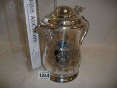 A silver plated lidded wine jug