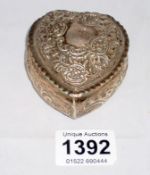 A silver heart shaped trinket box
