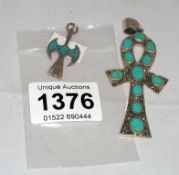 A large silver and turquoise cross and a small silver pheonix