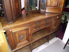 An oak 2 door 2 drawer sideboard with sunflower carving