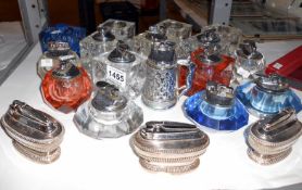 A quantity of cut glass lighters including Ronson