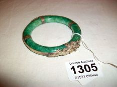 A jade and white metal bangle