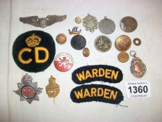 A tin of buttons and patches including WW2 silver US airforce pilots wings and silver watch fob
