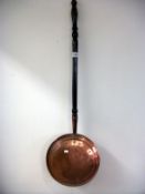 A Victorian copper warming pan