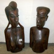 A pair of carved hardwood ethnic busts