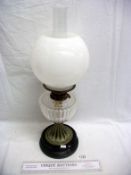 A Victorian oil lamp with glass font and opaque shade
