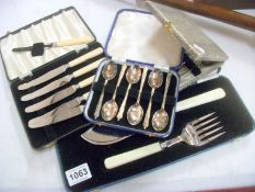 2 cased sets of spoons, cased set of knives and fish servers