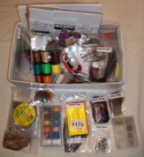 A boxed set of fly tying tools and items for making flies