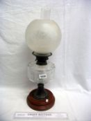 A Victorian oil lamp with glass font and etched shade