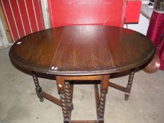 An oak barley twist leg gate leg table