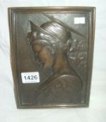 A bronze plaque of a lady