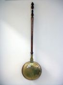 A Victorian brass warming pan