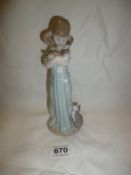 A Lladro figure of a girl with cat