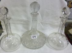 A pair of decanters and a cut glass ship's decanter