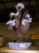 A pink glass epergne having a central trumpet, 3 smaller trumpets and 3 baskets